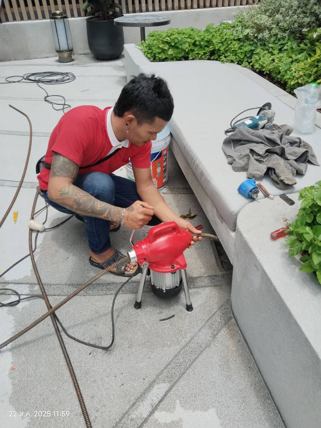 Technician running an electric drain cleaning machine