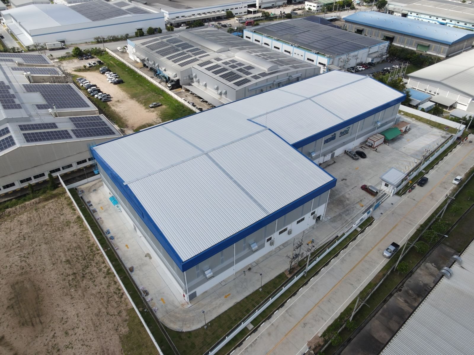 Aerial view of a factory with a loading yard