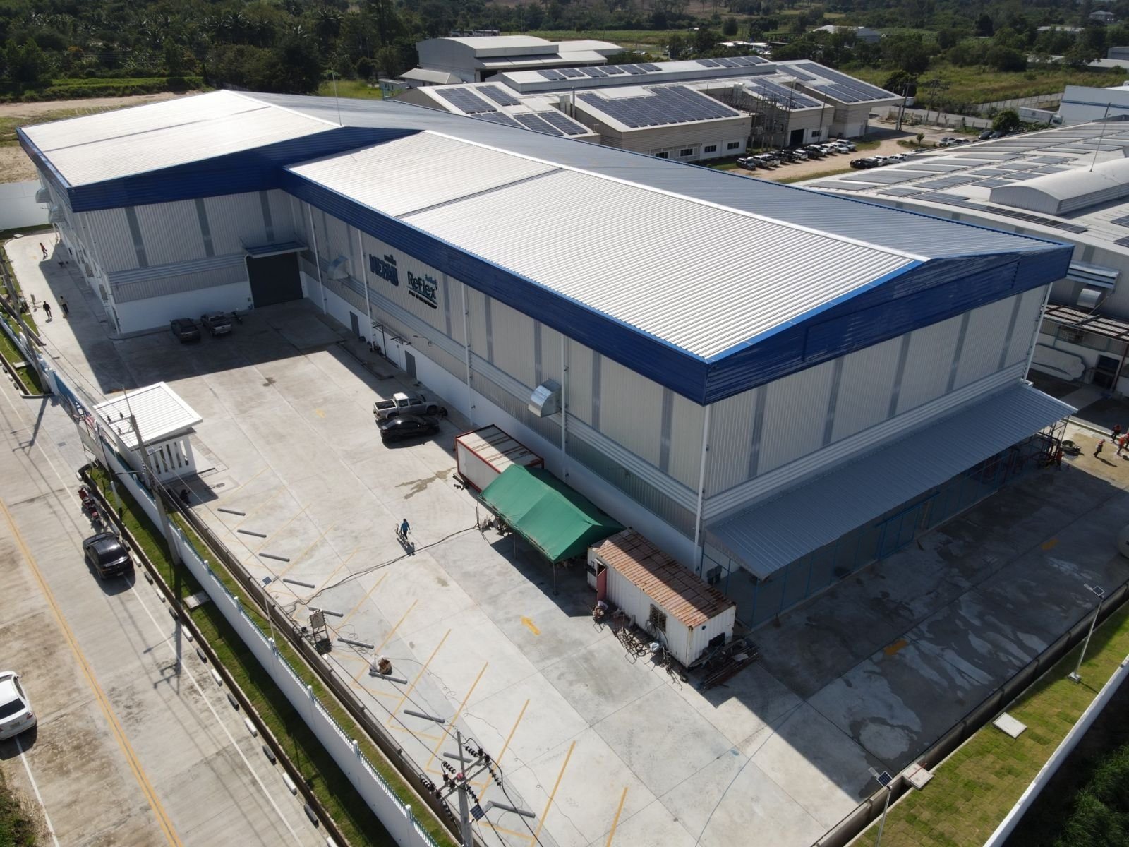 Aerial view of a factory with an office wing at the front