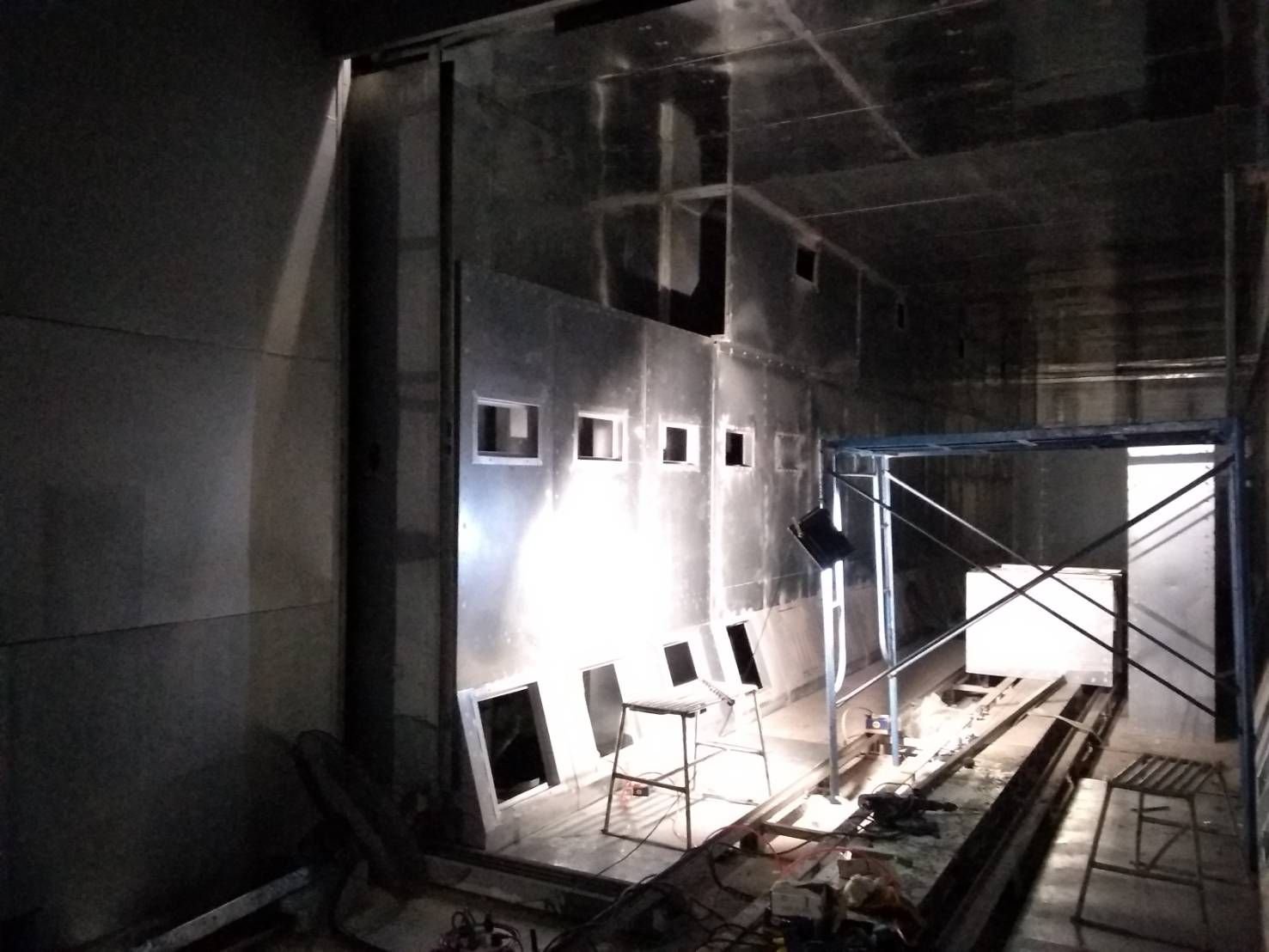 Inside a booth during installation, with lighting panels